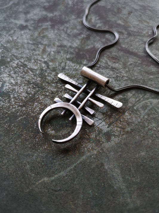 A necklace with a geometric silver pendant