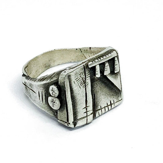 A silver, oxidized and brushed finish ring with a geometric design, signet-style, on a white background.