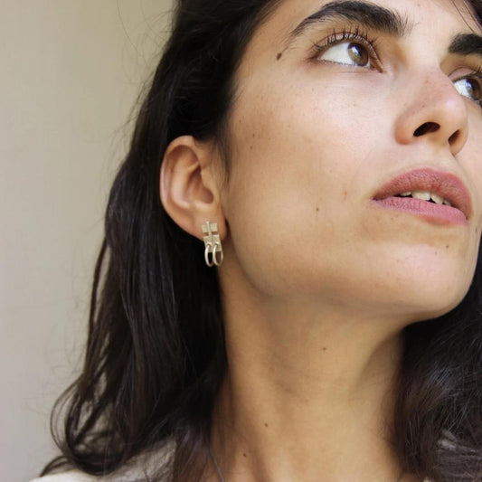 A pair of silver oxidized and brushed finish earrings with a geometric design