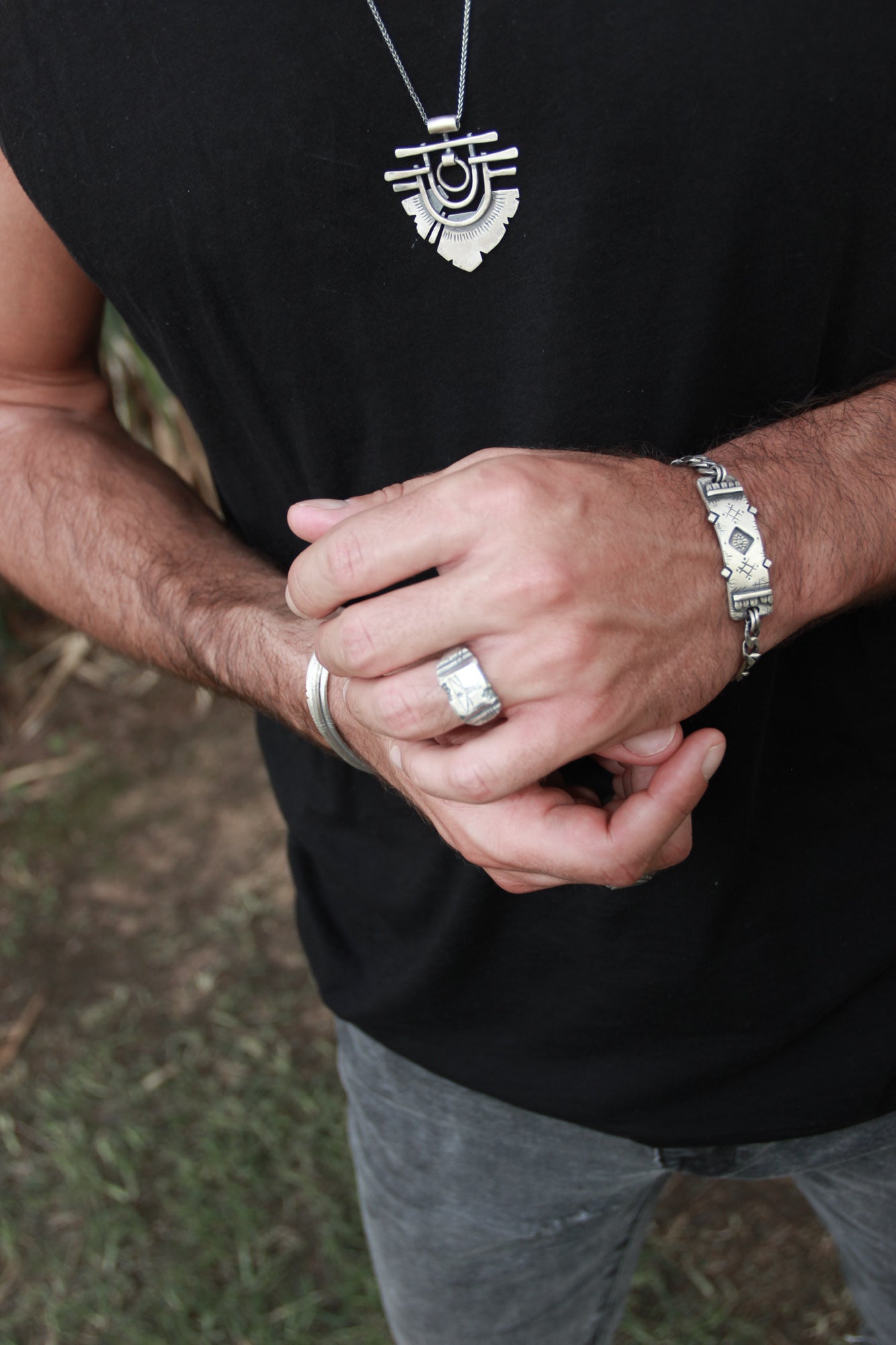 Men wearing silver shelly ganz ring. touch the fire necklace and a silver bracelet