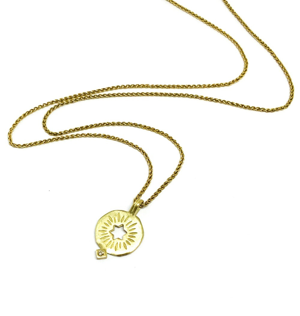 A golden rising star of david pendand on a chain