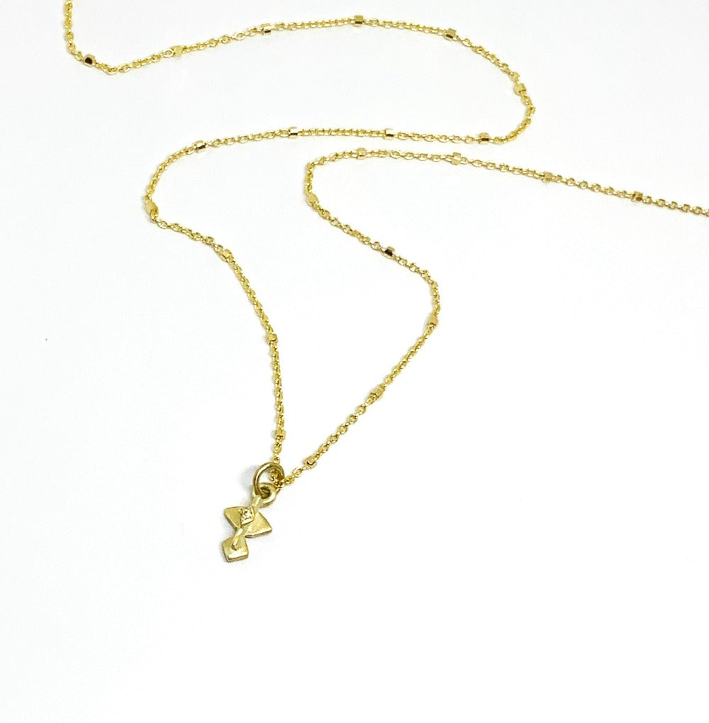 A golden necklace with a white diamond pendant 
