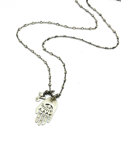 A silver Hamsa necklace with a brushed finish and a chain length of 42 cm, featuring a pendant with a Hamsa hand design.