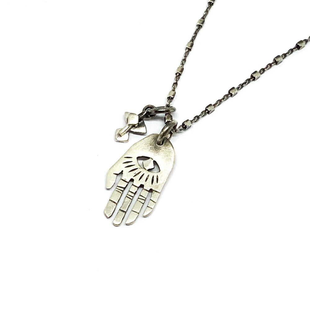 A silver Hamsa necklace with a brushed finish and a chain length of 42 cm, featuring a pendant with a Hamsa hand design.