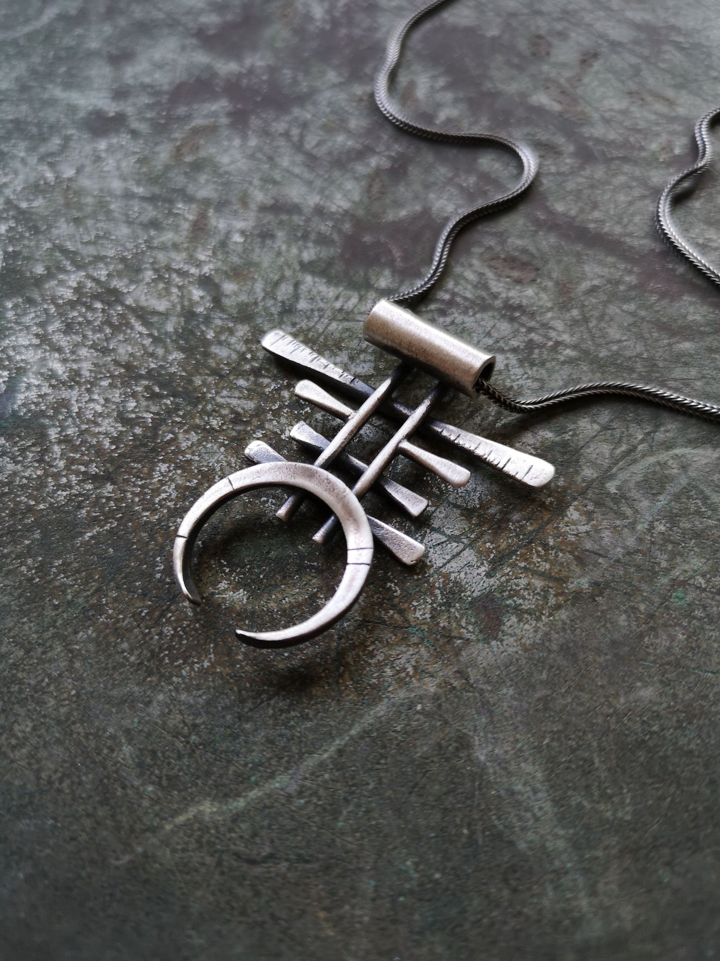 A necklace with a geometric silver pendant 