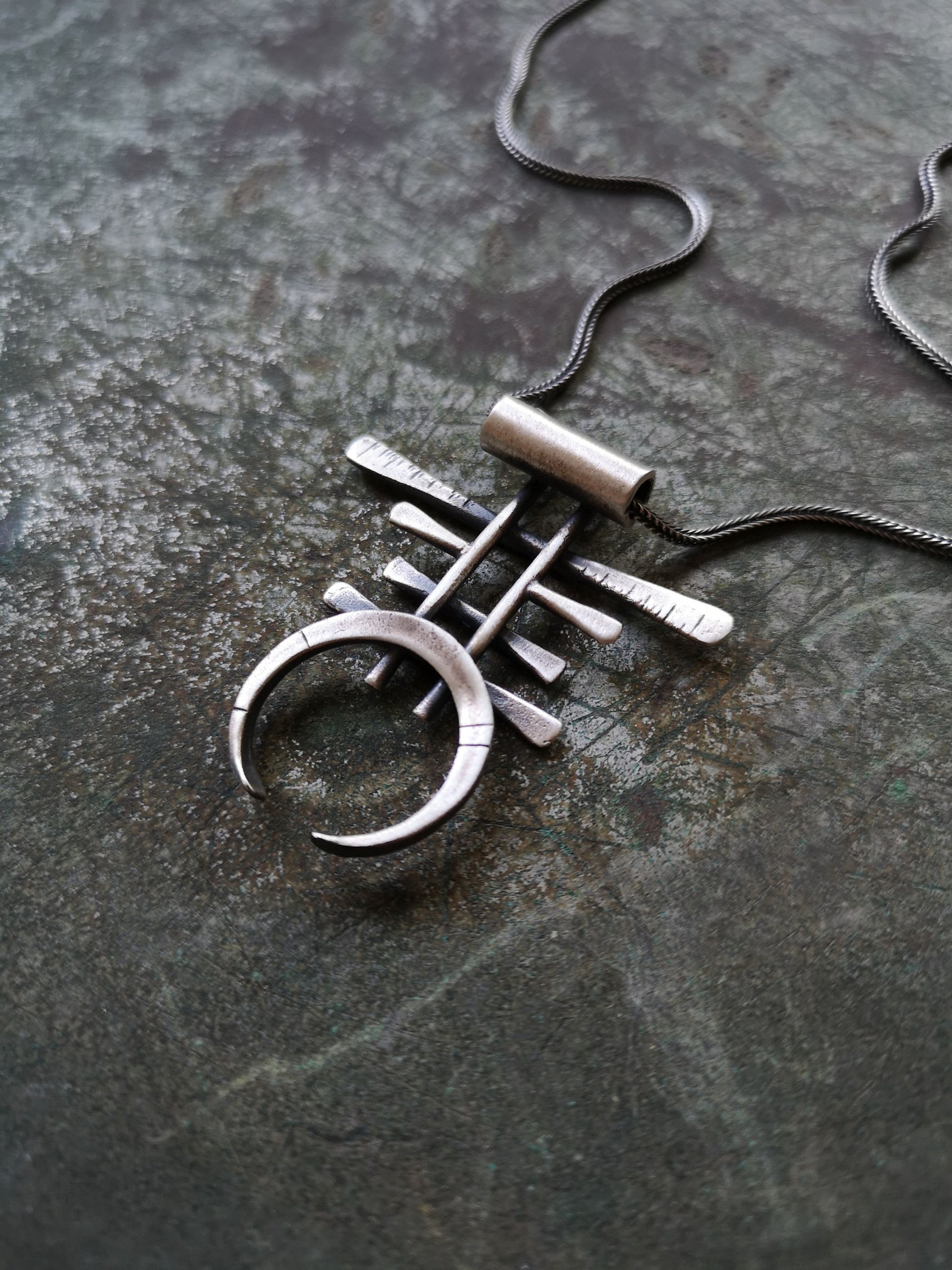 A necklace with a geometric silver pendant 