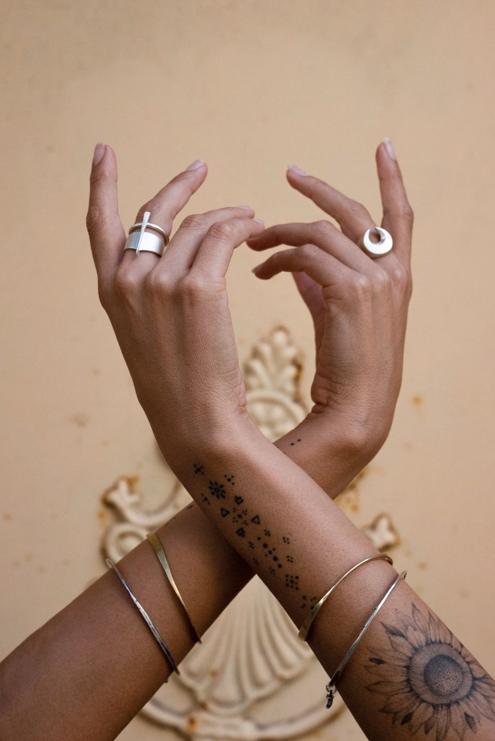A silver signet ring with a brushed finish, featuring a crescent moon design.