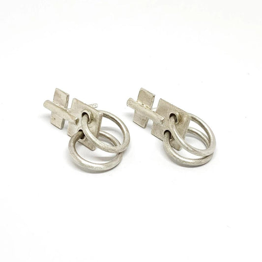 A pair of silver oxidized and brushed finish earrings with a geometric design