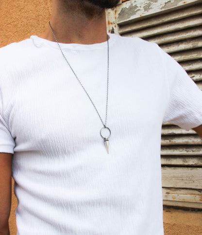 A sterling silver pendulum necklace with a brushed finish and a chain loop at the top. The pendulum is large and has a smooth, polished appearance.