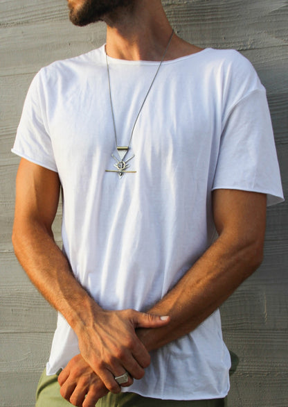 A silver and brass necklace with a geometric pendant, featuring a chain and a series of geometric shaped pendants attached to it.