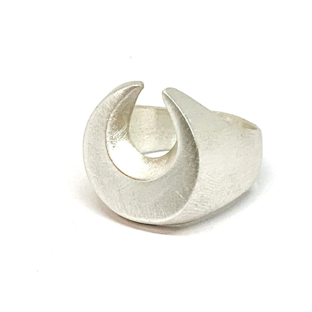 A silver signet ring with a brushed finish, featuring a crescent moon design.