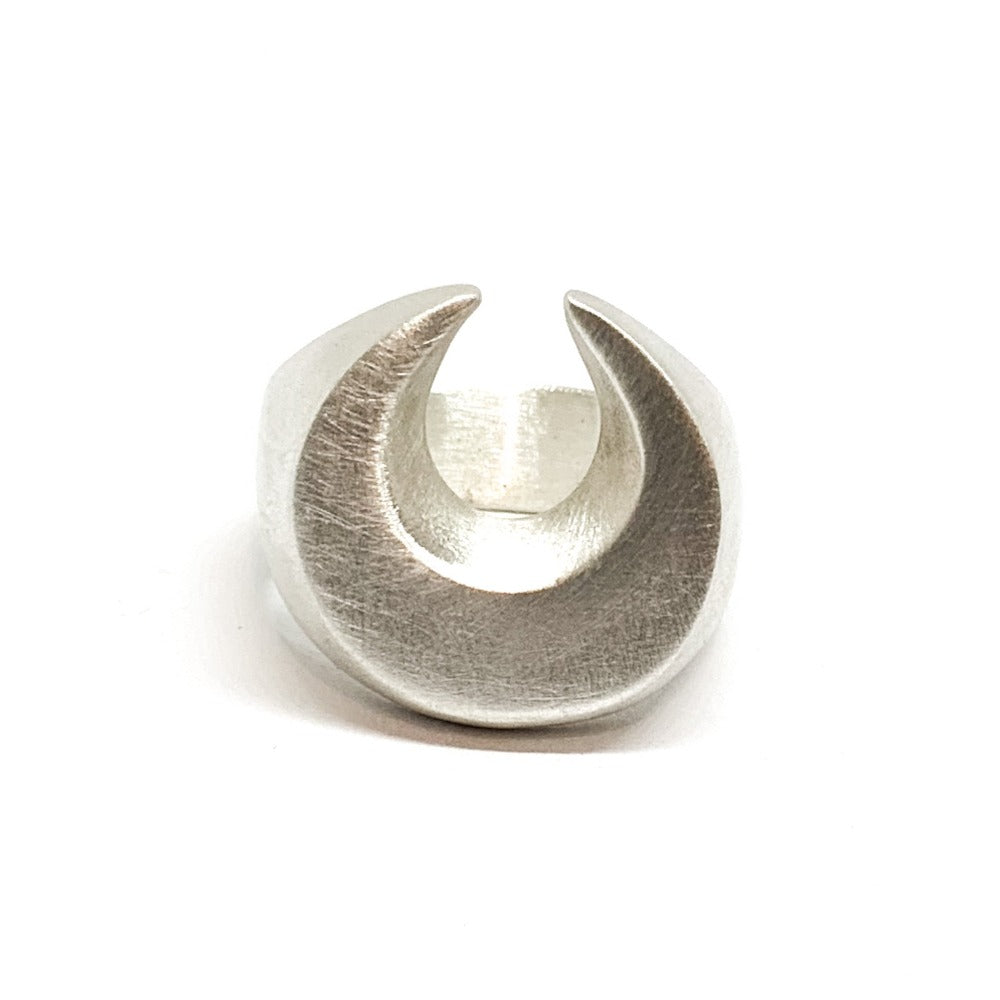A silver signet ring with a brushed finish, featuring a crescent moon design.