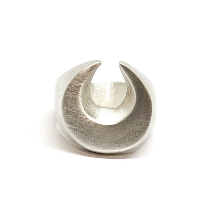 A silver signet ring with a brushed finish, featuring a crescent moon design.
