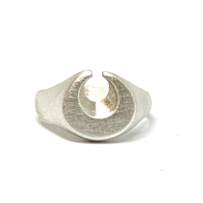 A silver ring featuring a brushed finish, handcrafted in the shape of a moon.