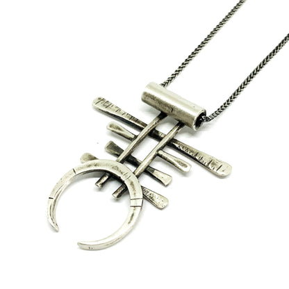 A necklace with a geometric silver pendant 