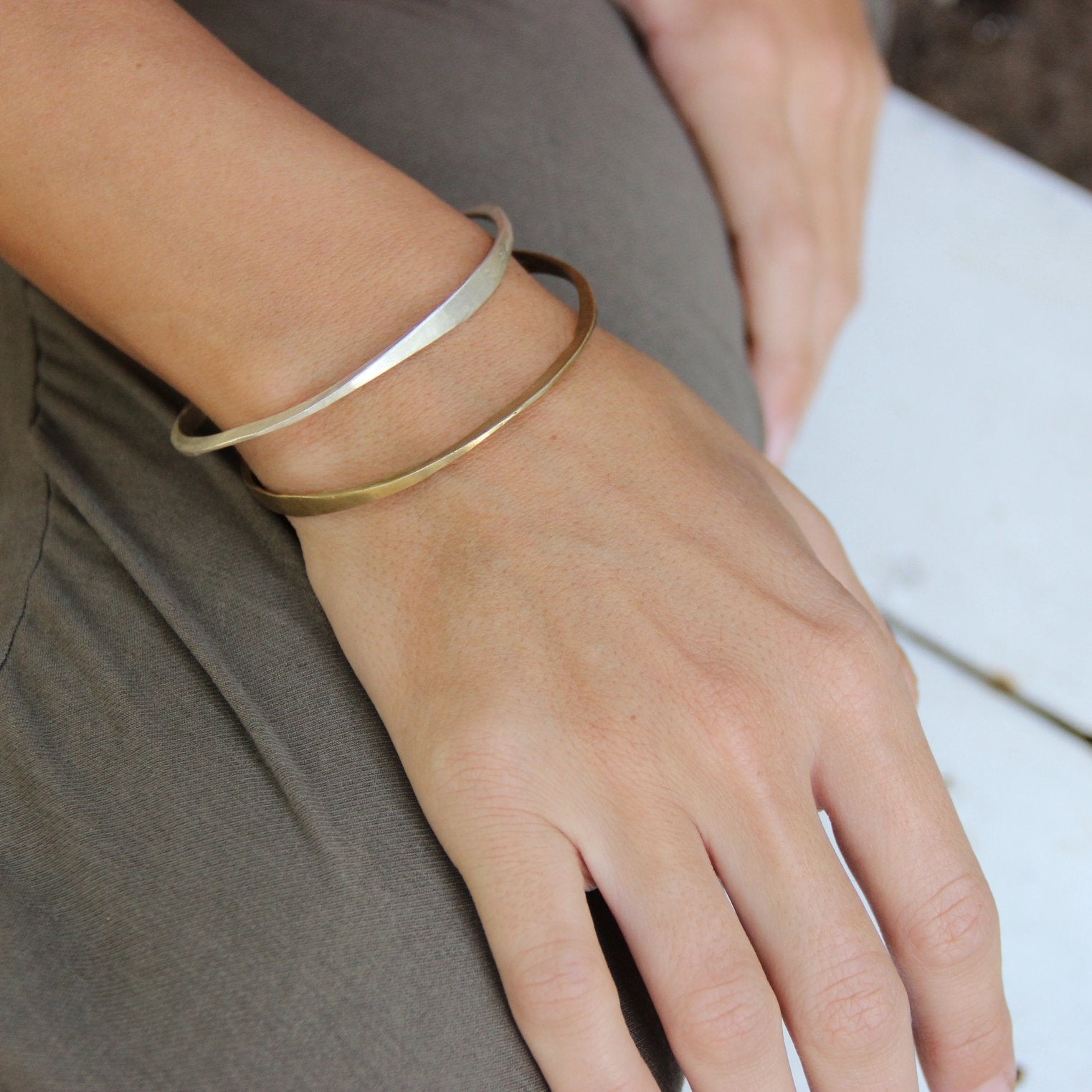 A silver bracelet with a brushed finish