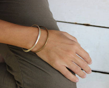 A silver bracelet with a brushed finish