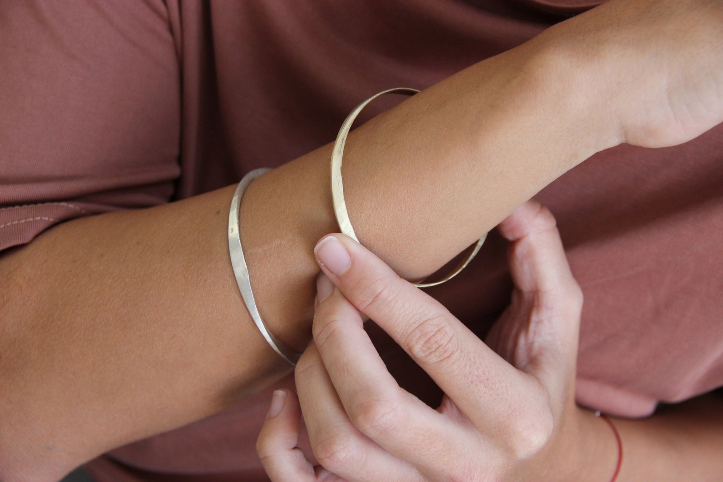 A silver bracelet with a brushed finish