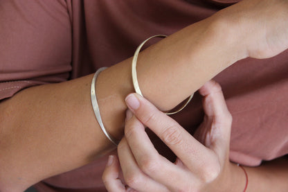 A silver bracelet with a brushed finish