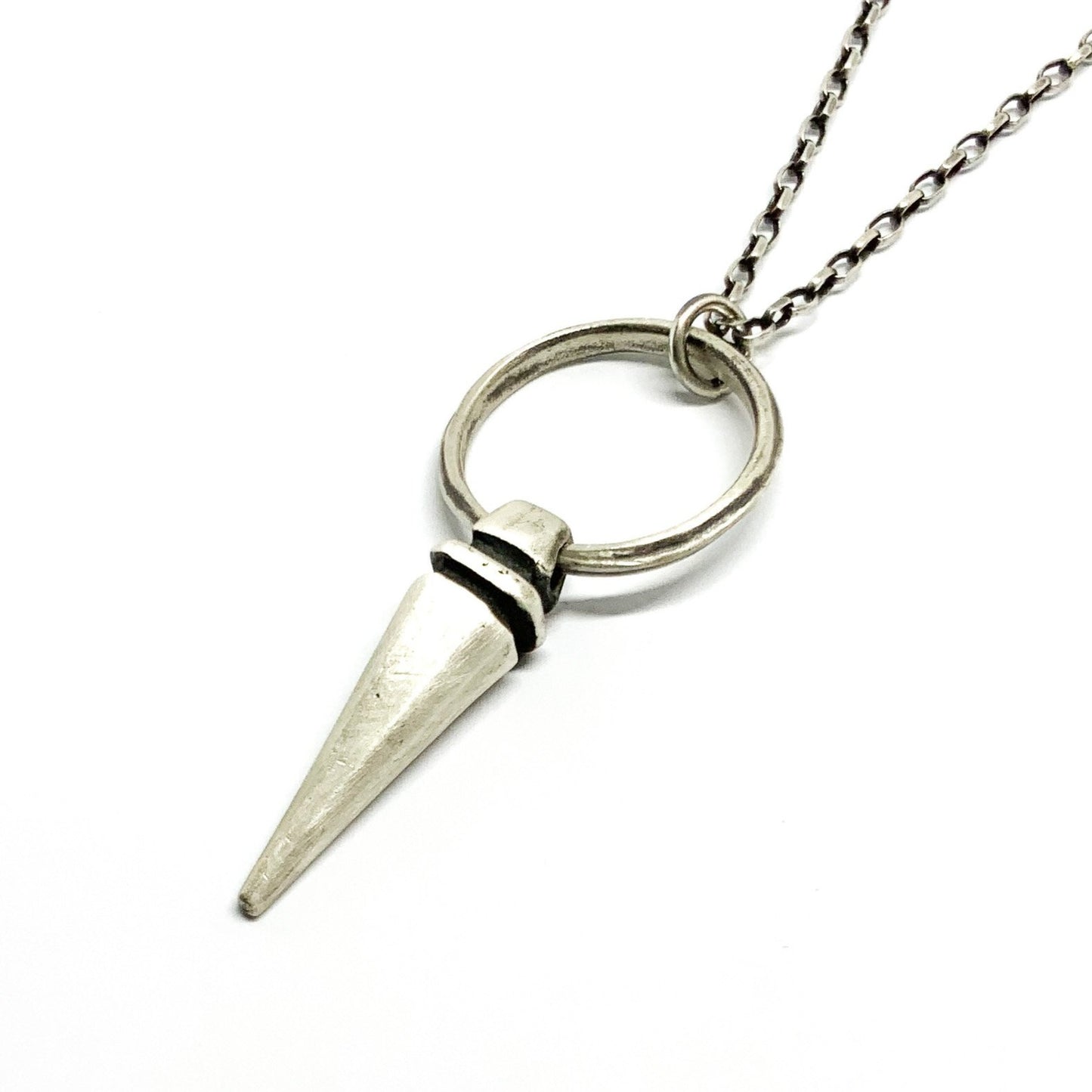 A sterling silver pendulum necklace with a brushed finish and a chain loop at the top. The pendulum is large and has a smooth, polished appearance.