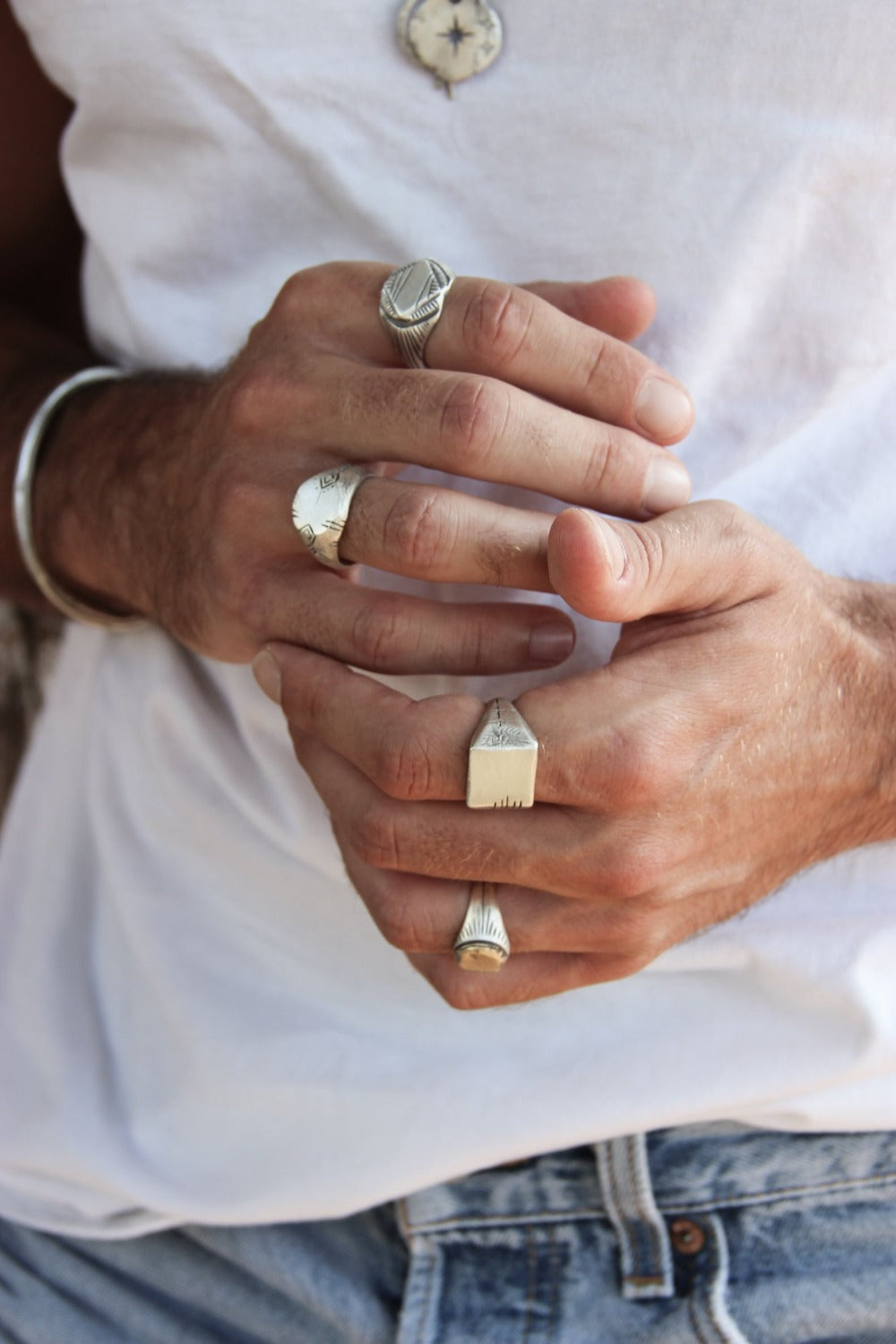 A silver carved memories ring with a textured and embossed pattern
