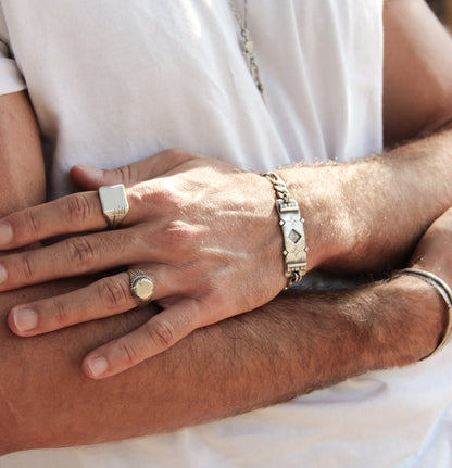 Men wearing silver shelly ganz rings and a silver bracelets