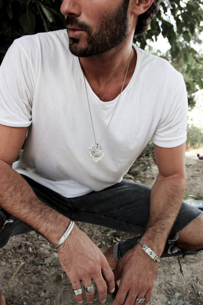 Men wearing silver shelly ganz rings. touch the fire necklace and a silver bracelets