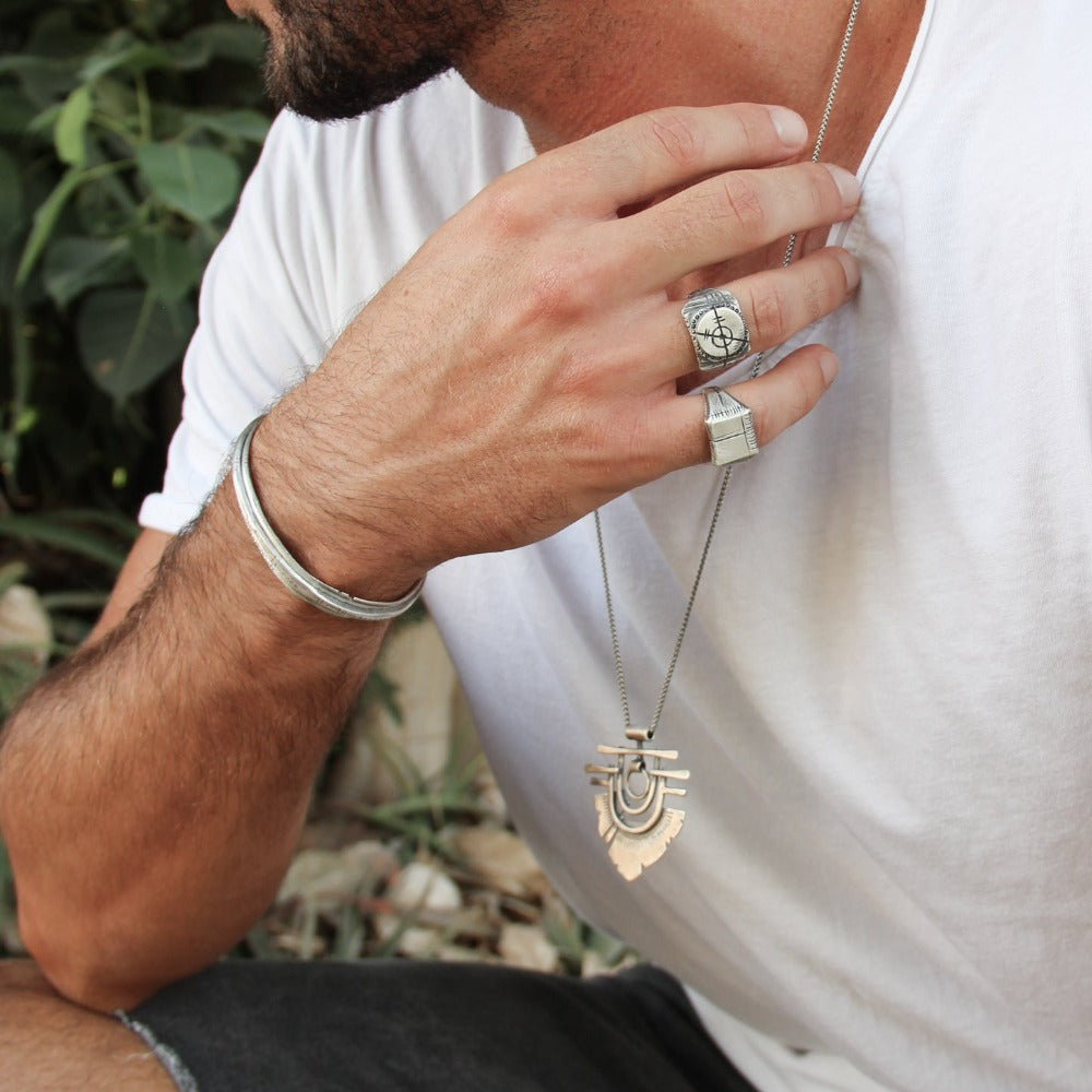 Men wearing silver shelly ganz rings. touch the fire necklace and a silver bracelets
