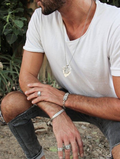 Men wearing silver shelly ganz ring. touch the fire necklace and a silver bracelet