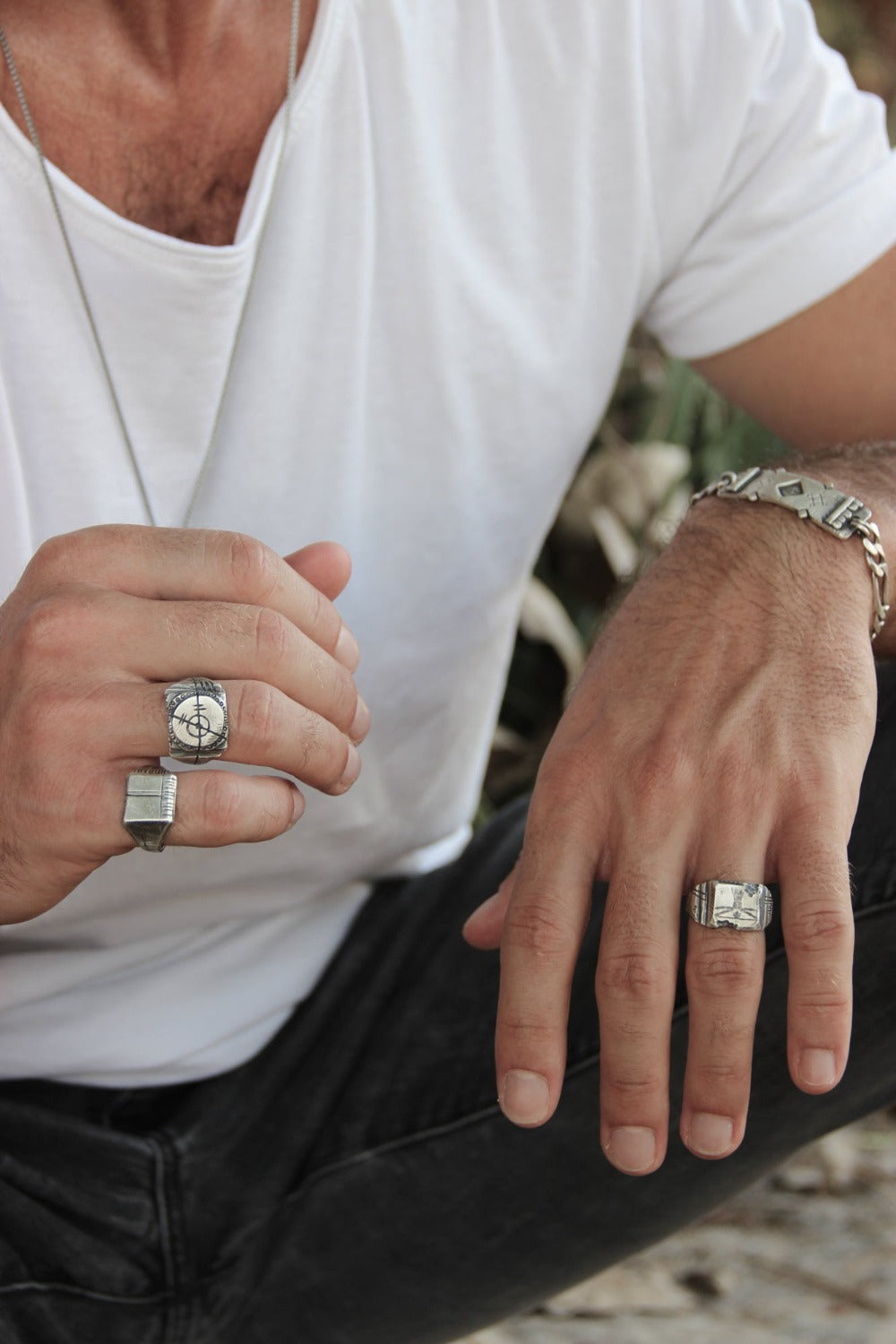 Men wearing silver shelly ganz rings. touch the fire necklace and a silver bracelets