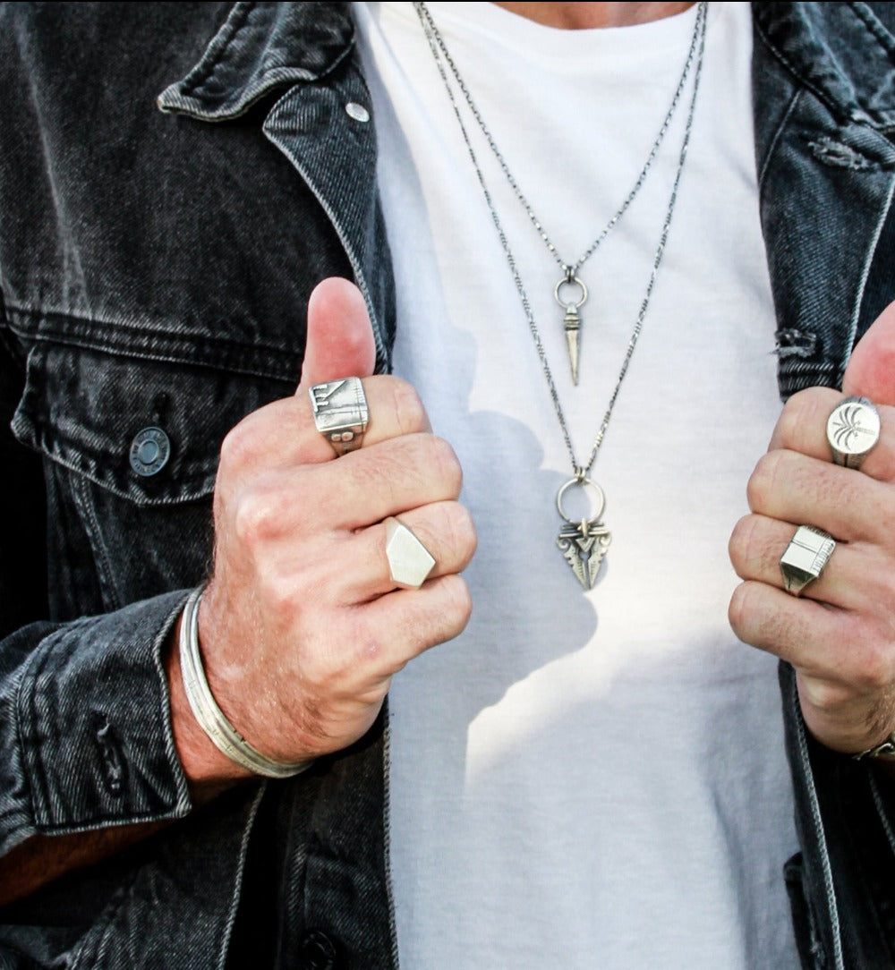 Men wearing 4 silver shelly ganz  silver rings and 2 necklaces 