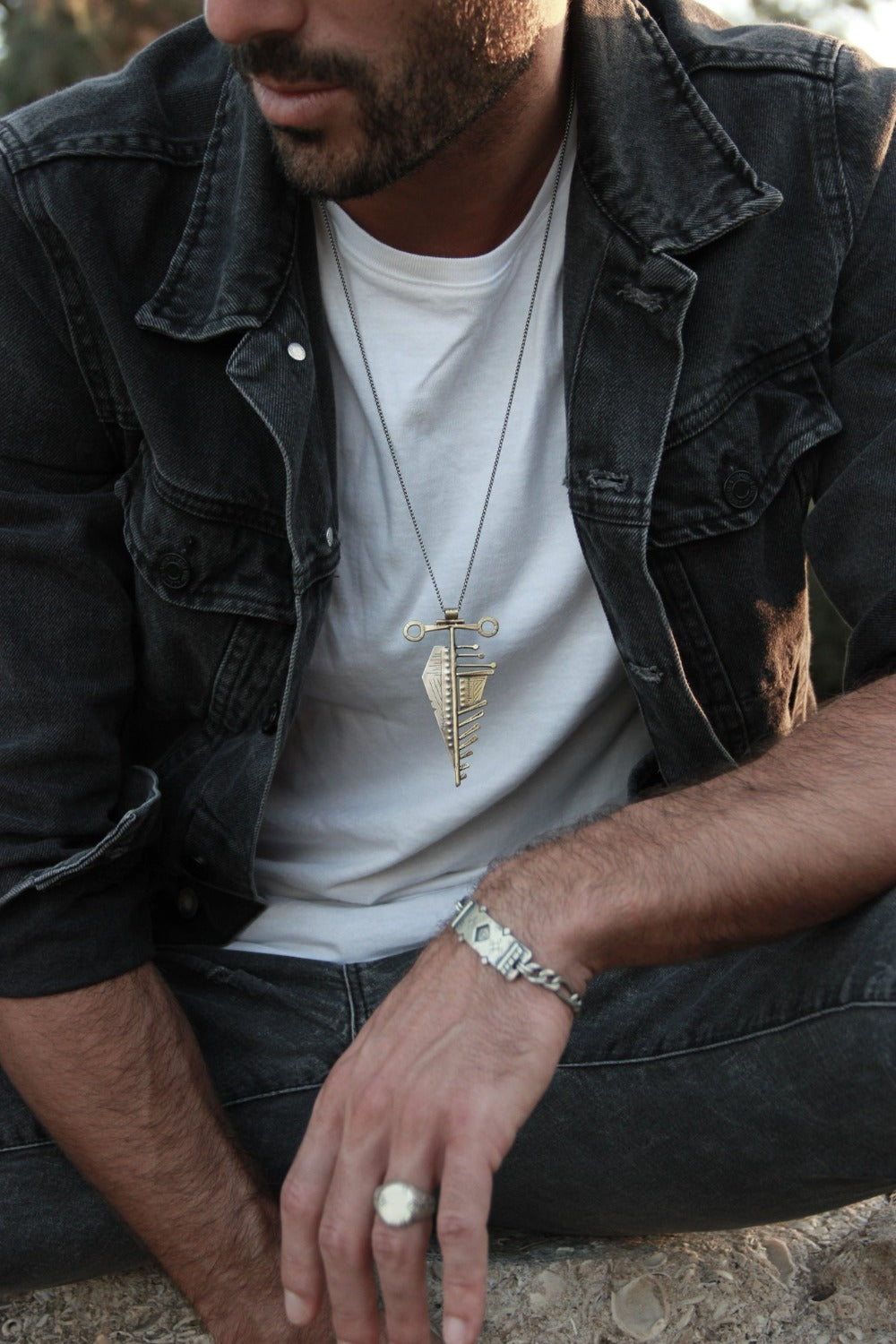 Men wearing silver shelly ganz rings: florence ring, nomad ring, and a silver bracelets