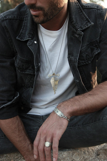 Men wearing silver shelly ganz rings: florence ring, nomad ring, and a silver bracelets