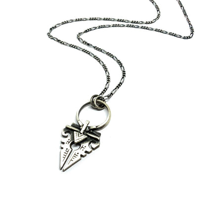 A sterling silver necklace with an oxidized and brushed finish, featuring a pendant with a strength symbol design.