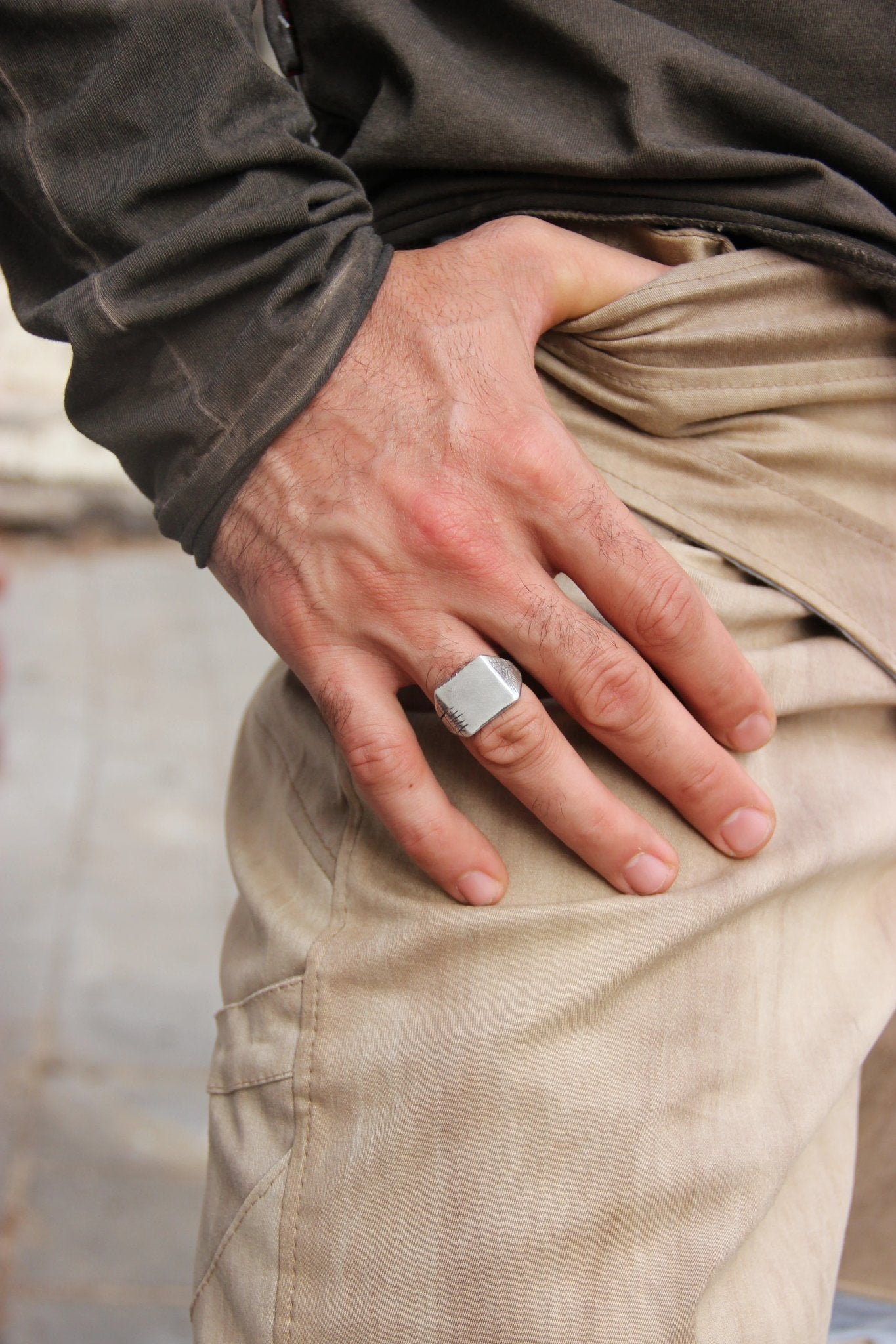 A silver carved memories ring with a textured and embossed pattern