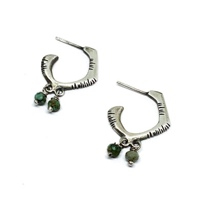 A pair of sterling silver oxidized and brushed finish earrings with turquoise accents and decorative stones.