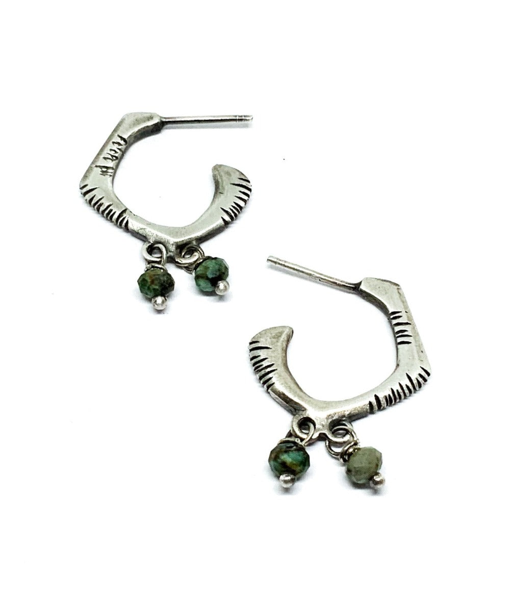 A pair of sterling silver oxidized and brushed finish earrings with turquoise accents and decorative stones.