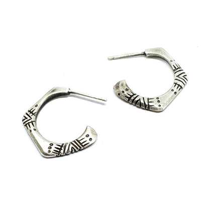 A pair of silver oxidized and brushed finish earrings with a geometric pattern, handcrafted.