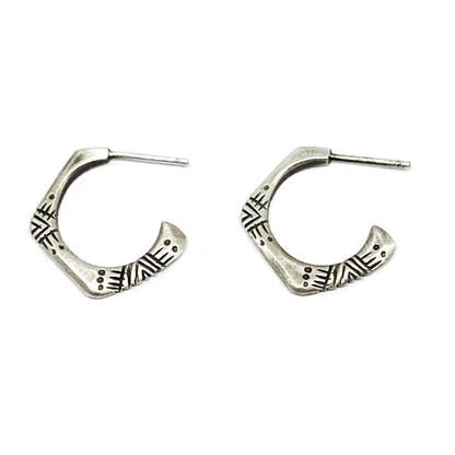 A pair of silver oxidized and brushed finish earrings with a geometric pattern, handcrafted.