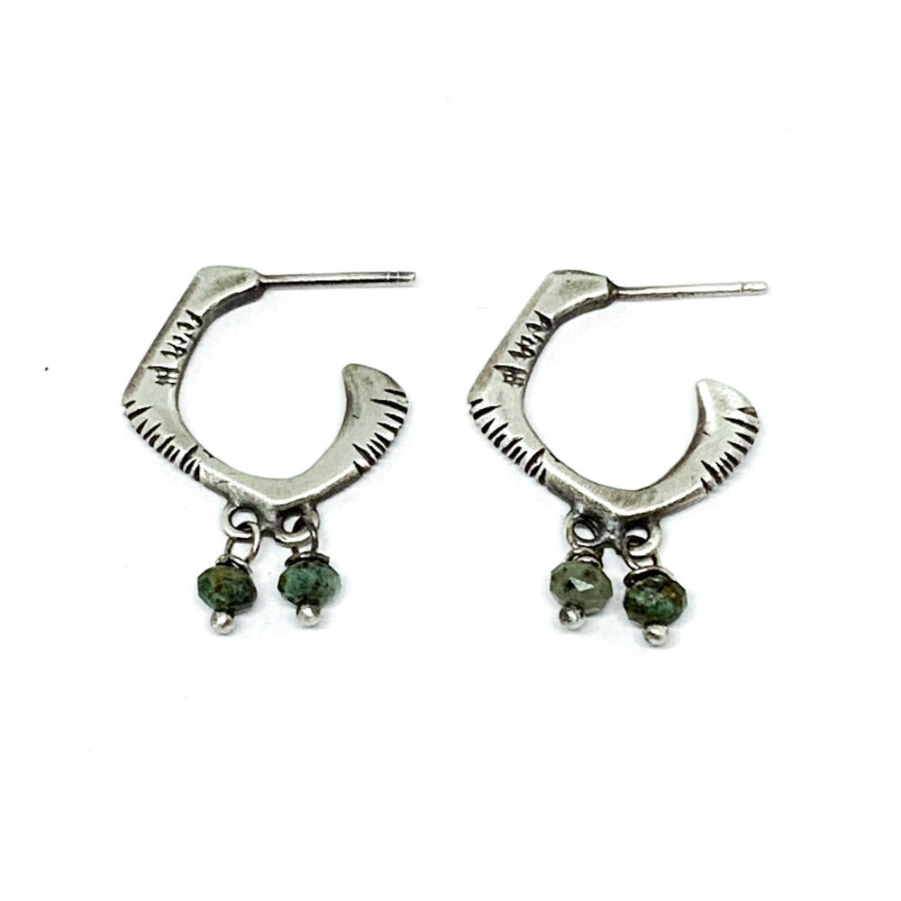 A pair of sterling silver oxidized and brushed finish earrings with turquoise accents and decorative stones.