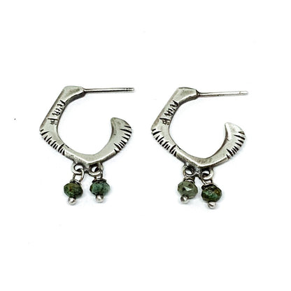 A pair of sterling silver oxidized and brushed finish earrings with turquoise accents and decorative stones.