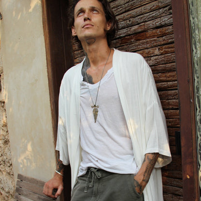A sterling silver and brass necklace with a pendant featuring a design that resembles an arrow, attached to a chain.