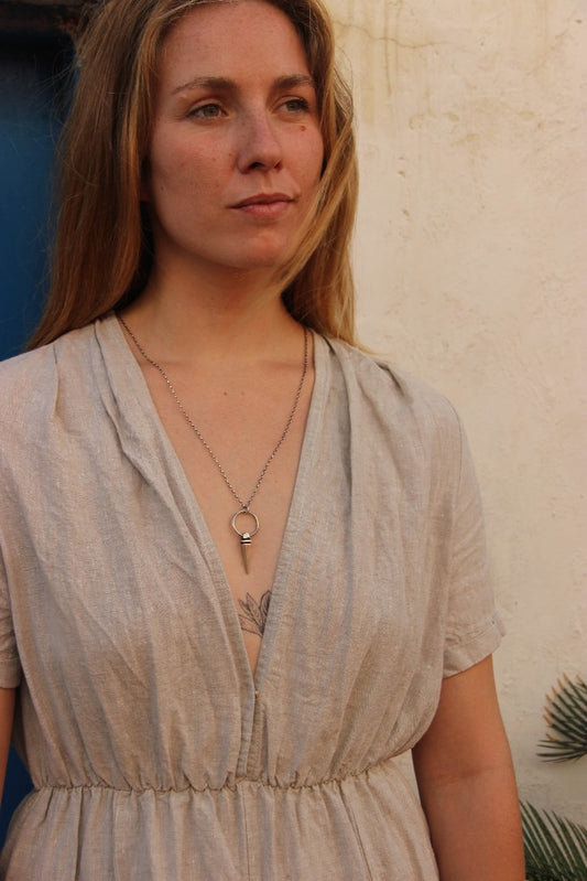 A sterling silver pendulum necklace with a brushed finish and a chain loop at the top. The pendulum is large and has a smooth, polished appearance.