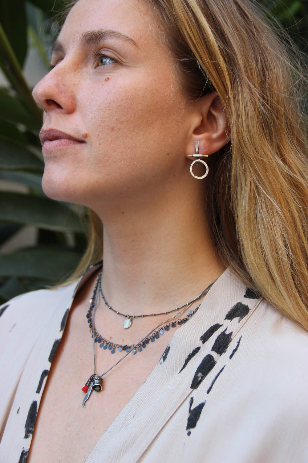 A pair of silver and brass earrings with a geometric design