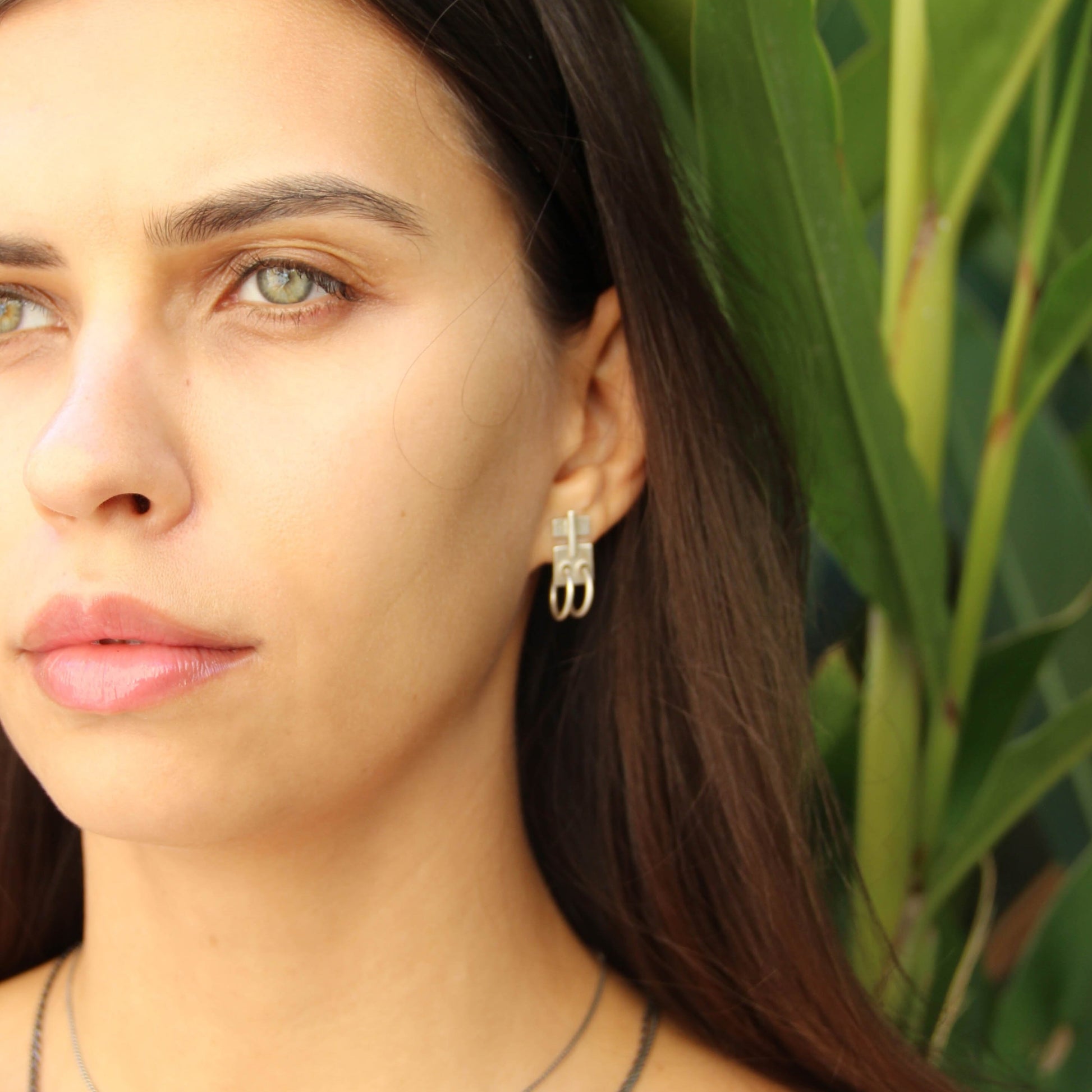 A pair of silver oxidized and brushed finish earrings with a geometric design