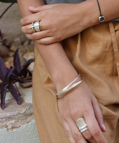 A silver bracelet with a brushed finish