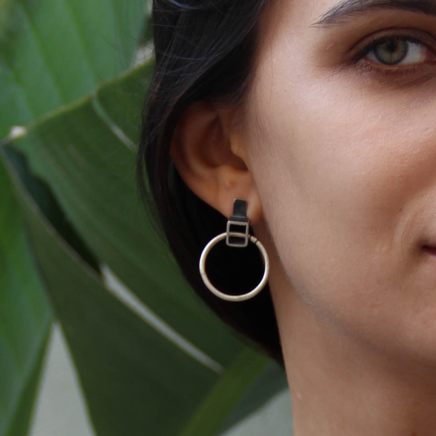 A pair of silver oxidized and brushed finish earrings with a geometric design