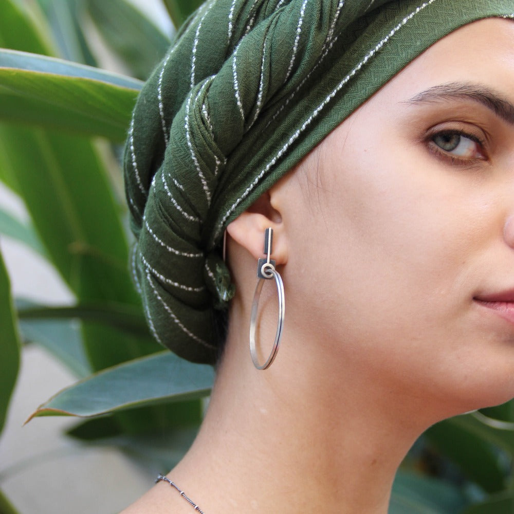 A pair of silver oxidized and brushed finish earrings with a geometric design