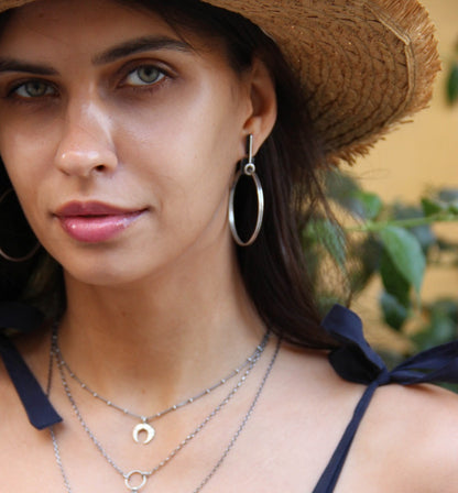 A pair of silver oxidized and brushed finish earrings with a geometric design