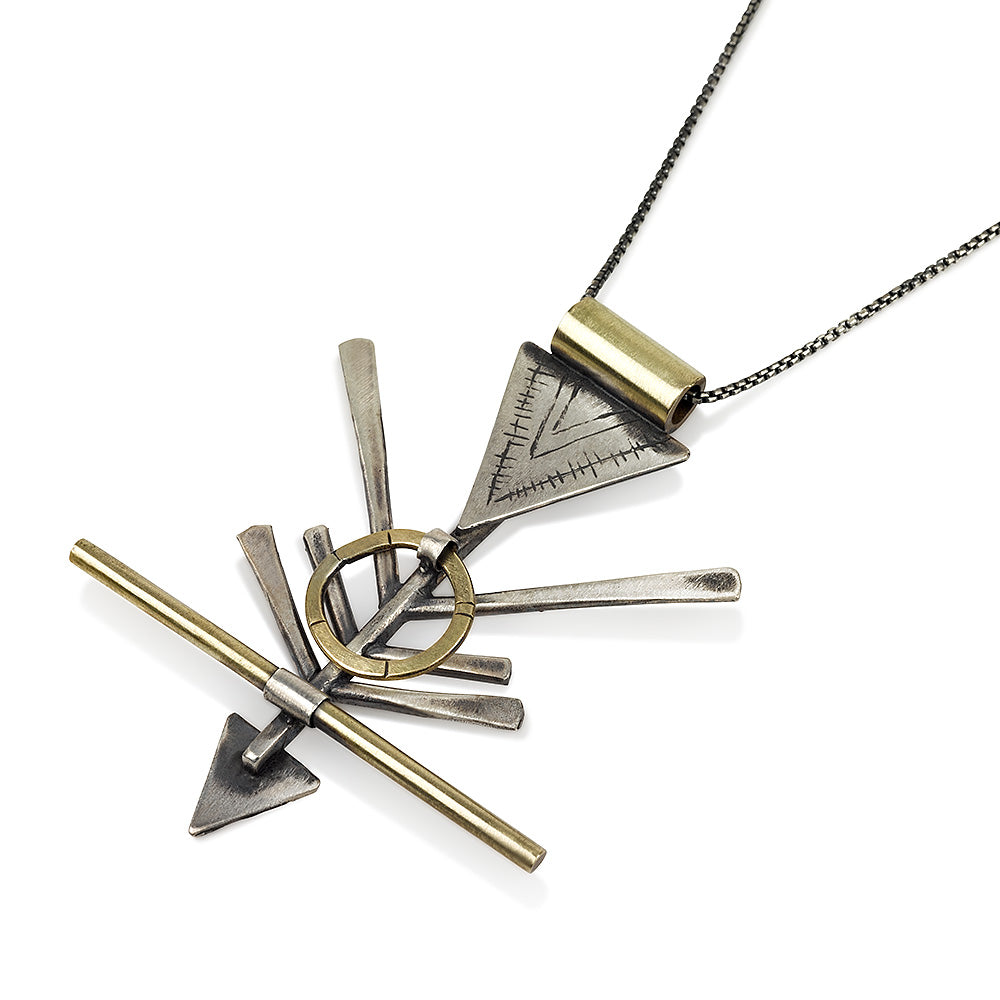 A silver and brass necklace with a geometric pendant, featuring a chain and a series of geometric shaped pendants attached to it.